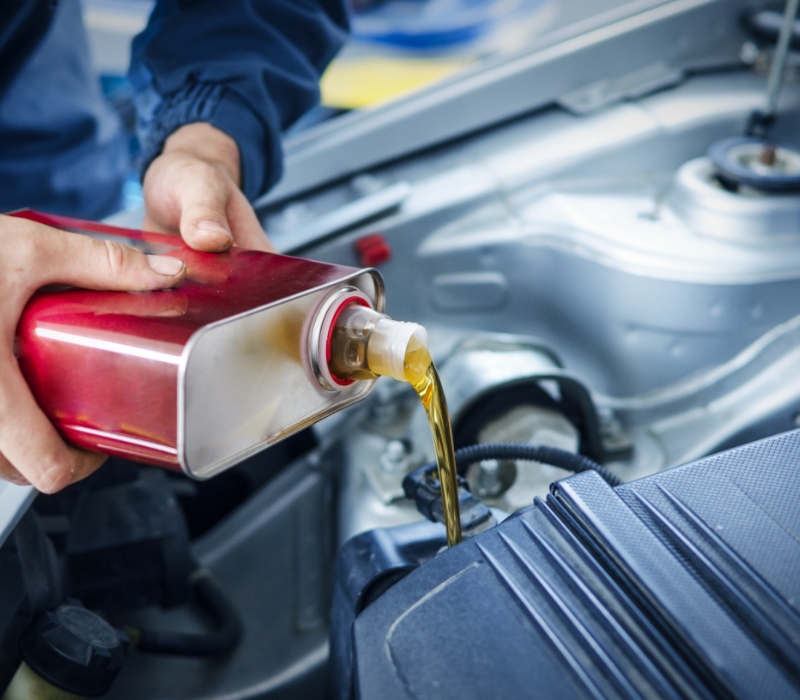 Mechanic changing engine oil on car vehicle 1.jpg